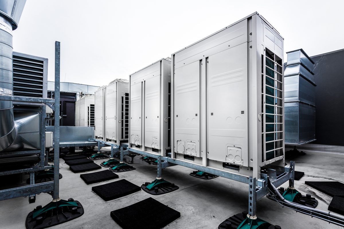 Rows of rooftop air-handling and ventilation units on a commercial building